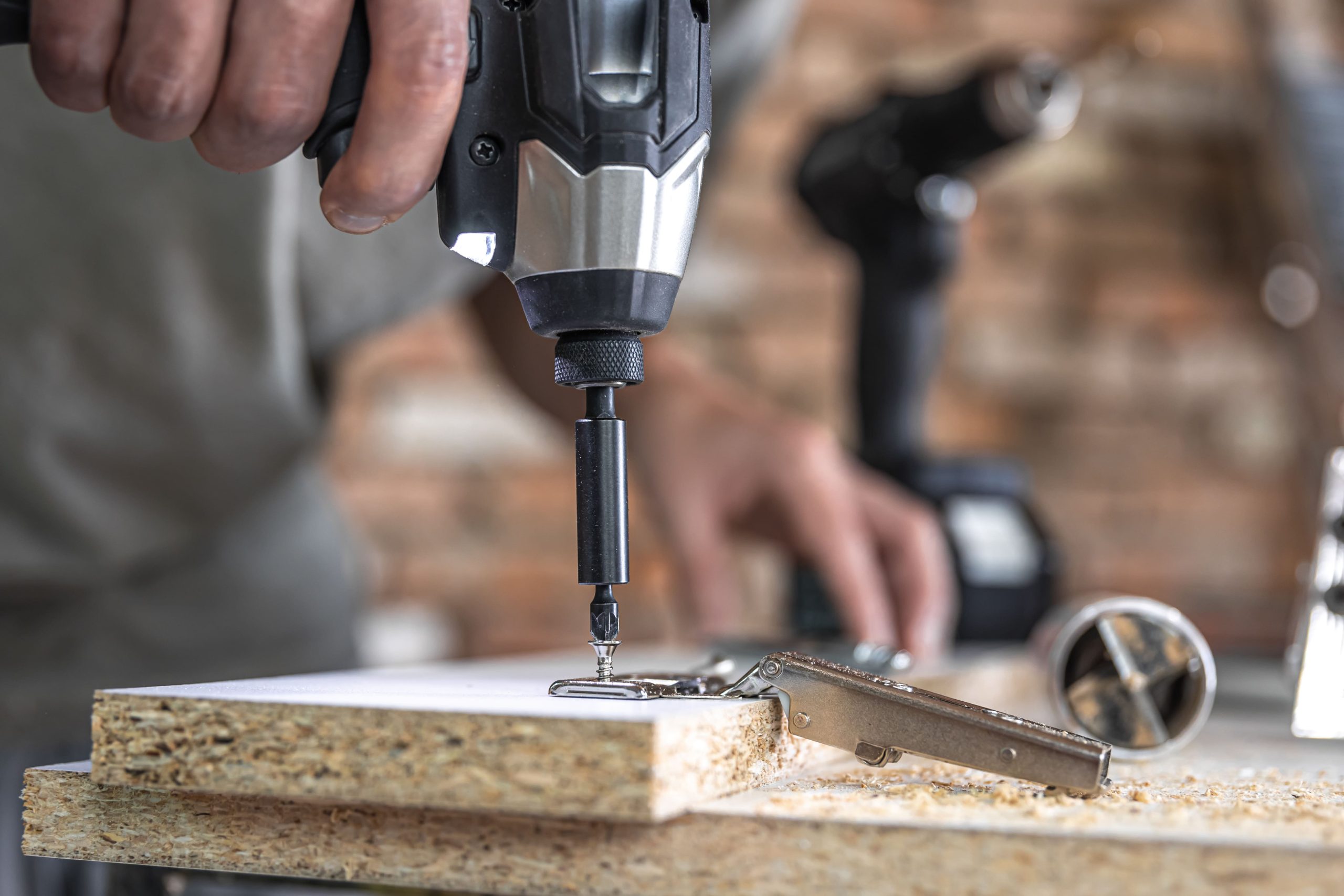 screwing-self-tapping-screw-into-metal-fastening-hole-wood-strip-using-screwdriver-work-carpenter